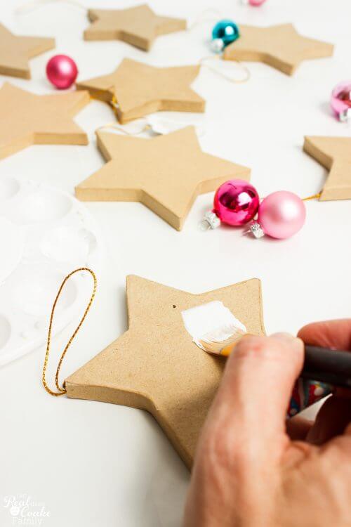 painting a paper mache star with primer I love Christmas Crafts! These DIY Christmas Ornaments will make the perfect theme for my Christmas Decorations.