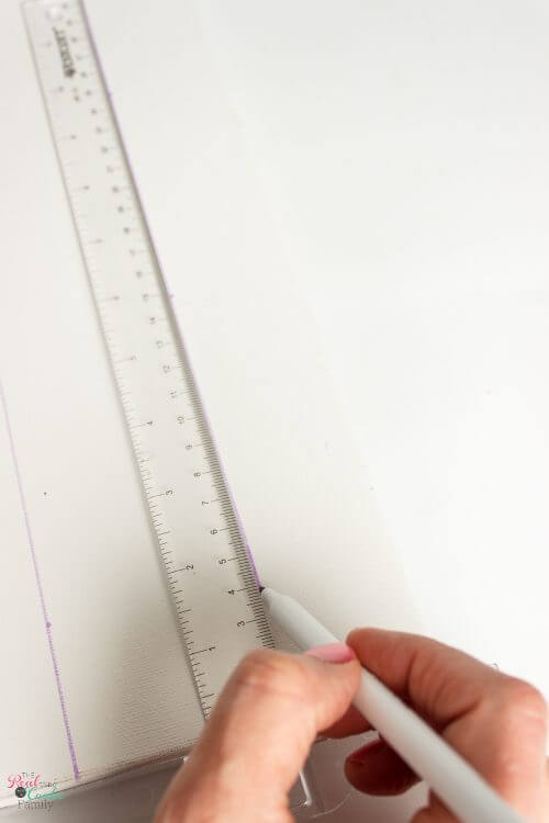 Using t-square to make lines for taping off Step by step tutorial on how to paint gingham and make the cutest wall art out of a craft store canvas. Perfect craft project to make DIY wall art.