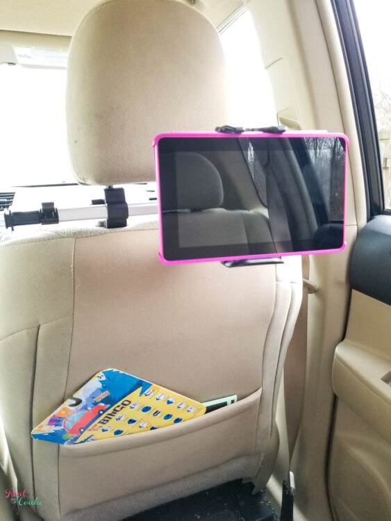 car tablet mount attached to a headrest List of travel accessories essential for a family road trip. Combo list of tech gadgets and accessories to make travel with the family easier and more fun.