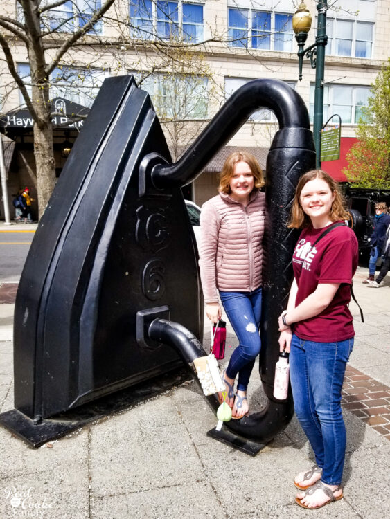 teen and tween with life sized iron in Asheville, NC Family vacation ideas for travel with teens and tween. Tips that help make family travel more fun along with an idea for a great destination in Tennessee.